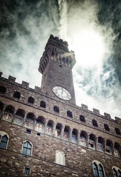The tower of Palazzo Vecchio, Florence, Italy on stunning dark cloudy sky