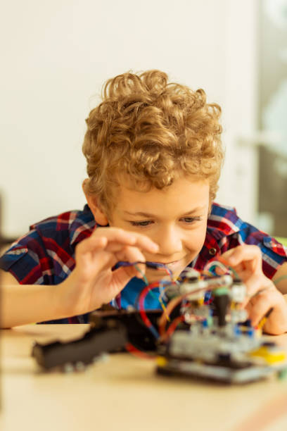 istock Happy cute boy working on his scientific project 1158467535