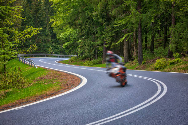 istock motorcyclist riding on the mountain road (HDRi) 1158474923
