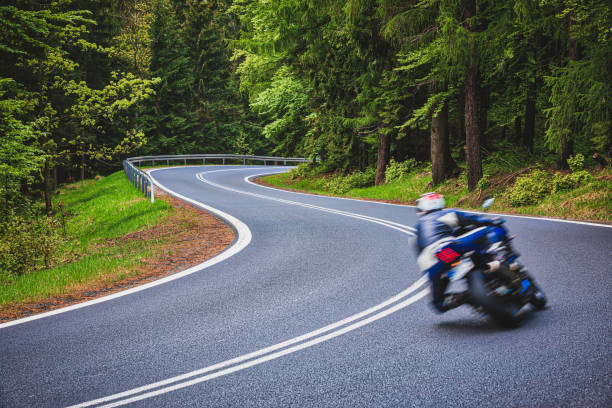 motorcyclist riding on the mountain road (HDRi) winding road in a green forest in the Karkonosze (Krkonoše) Mountains (Giant Mountains) karkonosze mountain range photos stock pictures, royalty-free photos & images