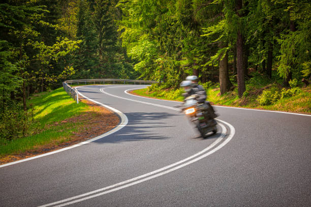 istock motorcyclist riding on the mountain road (HDRi) 1158474929