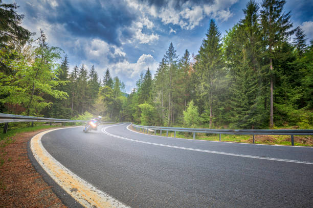 istock motorcyclist riding on the mountain road (HDRi) 1158474935
