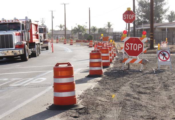 Stop Signs in work zone Stop Signs in Work Zone with Traffic Control in Perris California, No Walk Sign road construction photos stock pictures, royalty-free photos & images