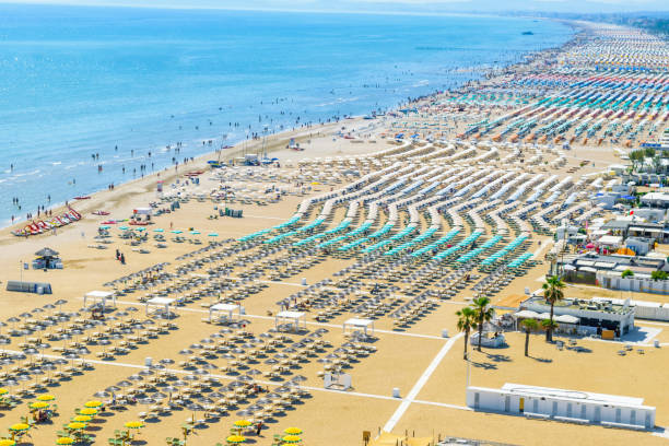 Aerial view of Rimini beach in Italy Aerial view of Rimini resort beach in Italy with a lot of parasols and sunbeds during summer time rimini stock pictures, royalty-free photos & images