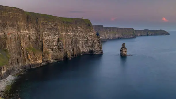 Photo of The stunning and majestic Cliffs of Moher in County Clare, Ireland at sunset, beautiful pink sky