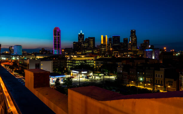 istock Dallas Texas Skyline Cityscape Glowing Purple Skyscraper at Blue Hour 1158477925