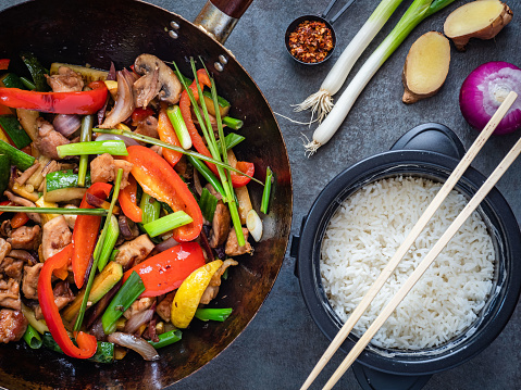 Thai stir fried chicken with vegetables and lemon grass, served with jasmine rice on the side.