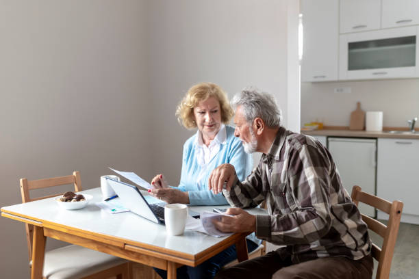 istock Senior Couple Calculating Bills 1158479294