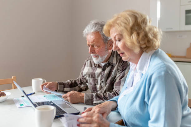 istock Senior Couple Doing Some Paperwork and Calculations at Home 1158479491