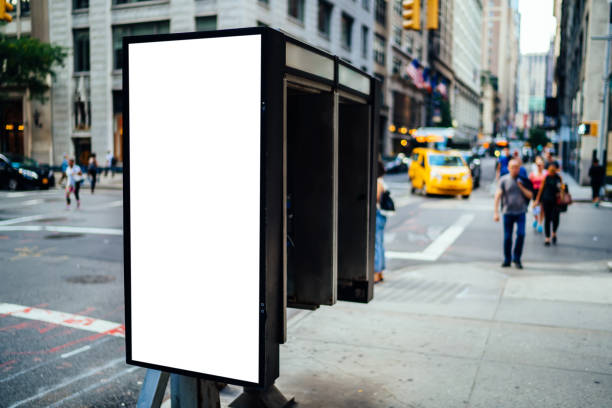 istock Empty billboard on telephone street box with copy space for advertising text message or content, public information board in urban scene, clear Lightbox with city on background, promotional mock up 1158479639