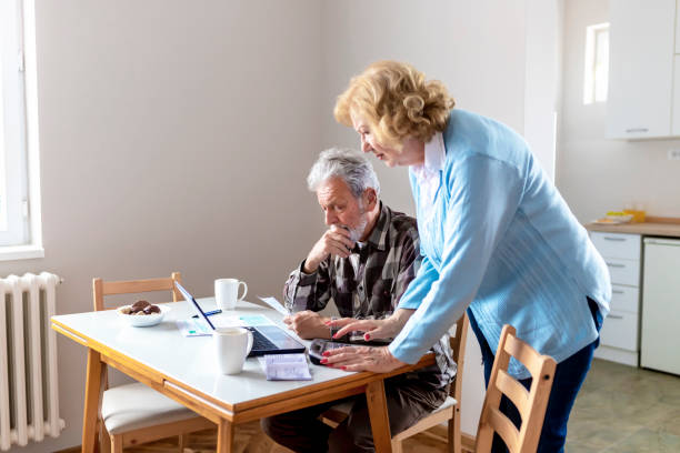 istock Senior Couple Doing Some Paperwork and Calculations at Home 1158480320