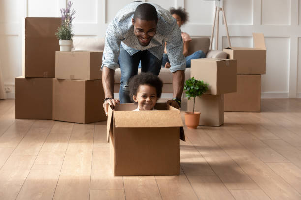 istock Happy african dad playing with little son riding in box 1158481689