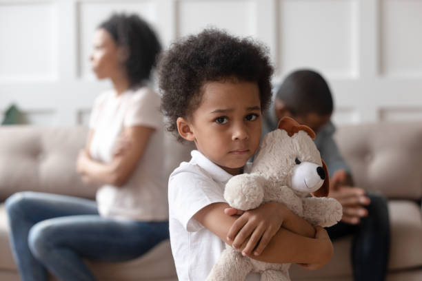 Upset little african child boy holding toy looking at camera Portrait of upset little african child boy holding toy looking at camera, sad sensitive small mixed race kid feel lonely hurt suffer from family conflicts fights, parents divorce, children custody arguing couple divorce family stock pictures, royalty-free photos & images