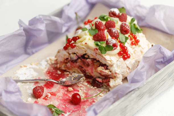 istock Small spoon and delicious meringue cake with ripe fruit are on a tray 1158482641