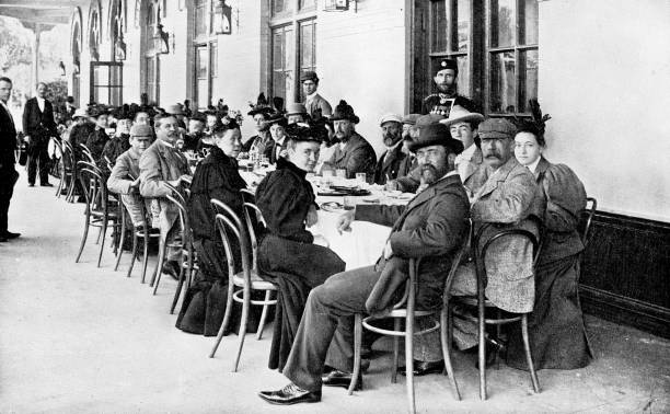 Large Group of People at a Train Station in Saint Petersburg, Russia - Russian Empire 19th Century Large group of men and women sitting at tables at a train station in Saint Petersburg, Russia. The Russian Empire era (circa 19th century). Vintage halftone photo etching circa late 19th century. russian culture photos stock pictures, royalty-free photos & images