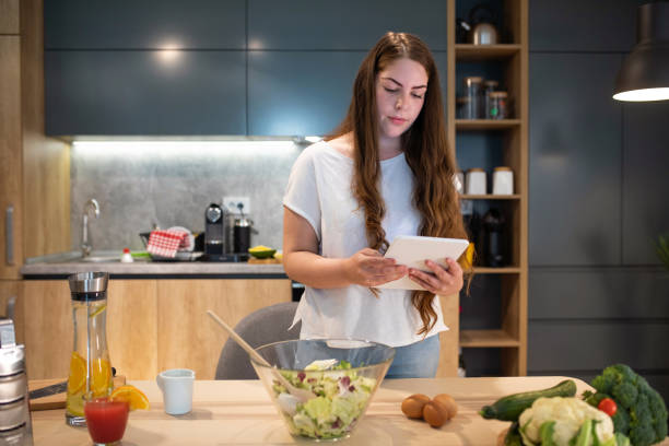 istock Woman checking a salad recipe online 1158484352