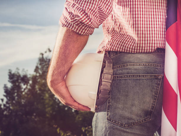 istock Young engineer, white hardhat and American Flag 1158484660