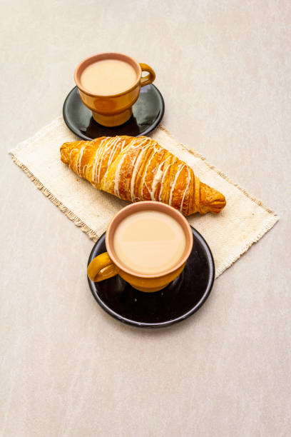 istock A cup of fresh coffee with croissant 1158484827