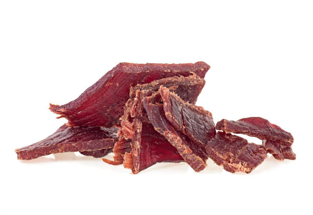 istock Portion of beef jerky on a white white background. Full depth of field. 1158484983