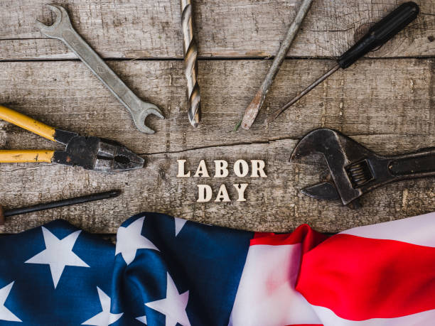 istock LABOR DAY. Hand tools and wooden letters 1158485648