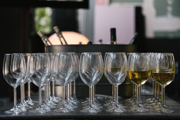 istock Glasses with white wine on the table for event 1158489202