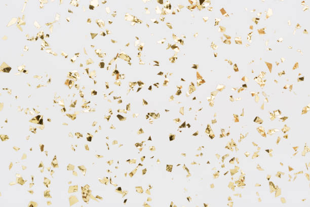 istock Golden confetti on white background Festive party or holiday glitter backdrop 1158489968