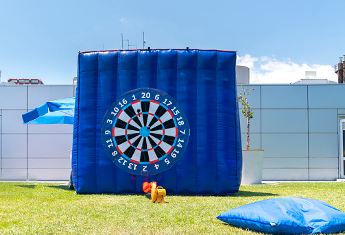 Giant inflatable dart board in outside/outdoor.
