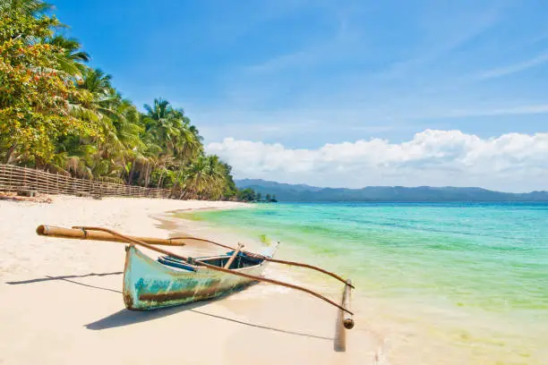 Photo of tropical boat on beautiful island beach