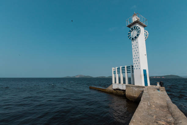 istock Lighthouse on the shore of an island 1158494507