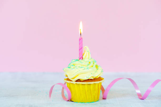 istock Birthday cupcake with decoration and burning candle 1158494510