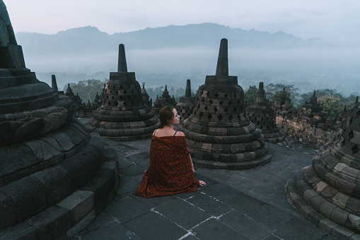 Woman traveler at  Prambanan temple near Yogyakarta city, Central Java, Indonesia