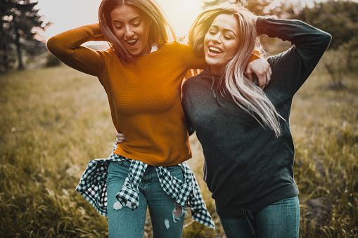 Teen girls having fun at sunset