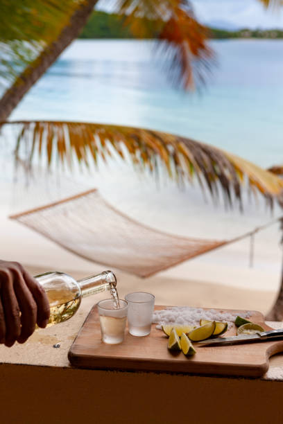 istock pouring tequilla with lime on a tropical beach in the caribbean 1158495440