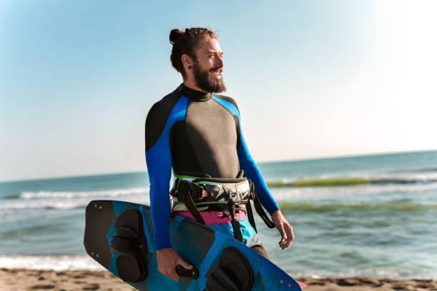 istock Photos Athletic man riding on kite surf board 1158496663