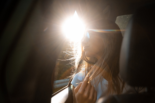 Beautiful woman traveling by the car window