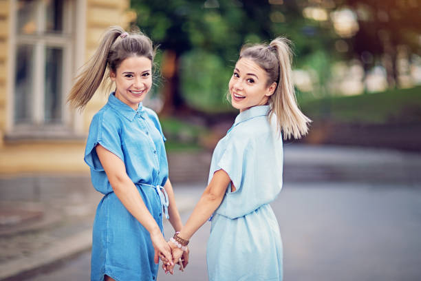 Twin sisters are walking on the street