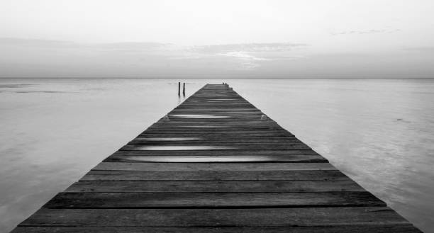 istock Wooden Jetty At Dawn Black and White 1158498320