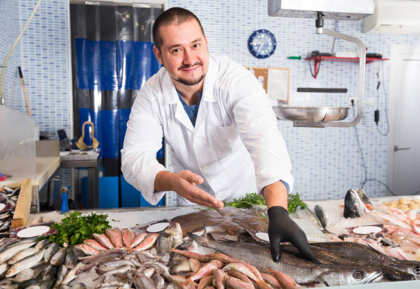 istock Seller shows hands fish on counter 1158498701
