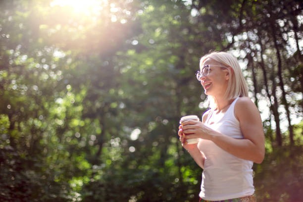 istock Woman drinking coffee while enjoying in nature 1158501585