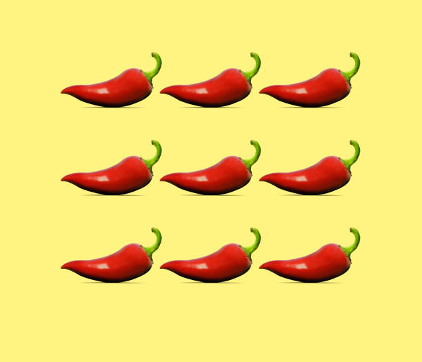 istock Red Jalapeno Pepper Pattern On A Yellow Background 1158505179