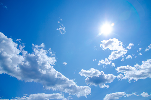 Sun and clouds in blue sky during summer day