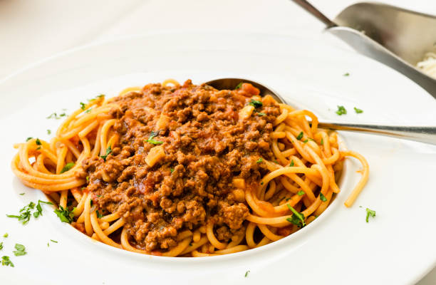 istock High angle view on spaghetti in a white plate on white table bolognese pasta 1158508792