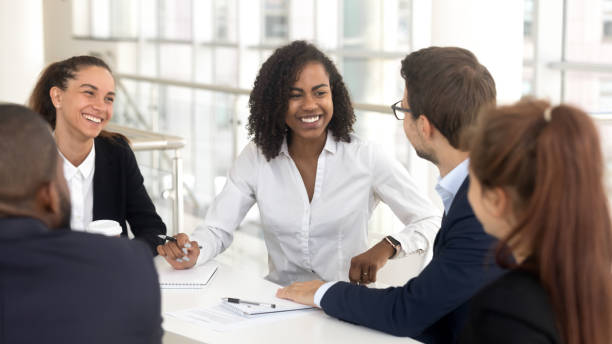 istock Smiling diverse employees discuss ideas brainstorming at office meeting 1158514067