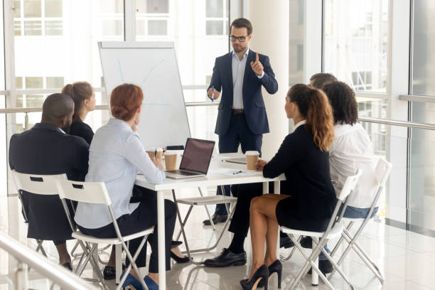 istock Male coach make whiteboard presentation for diverse employees 1158514074