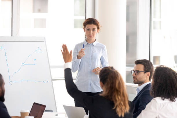 istock Female coach interact with employees at work office training 1158514078
