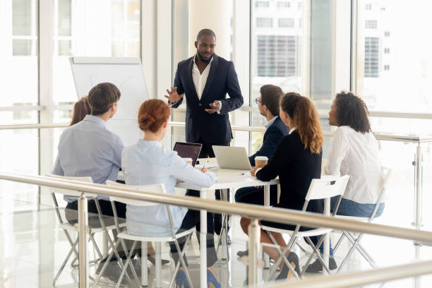 istock African American male coach make flip chart presentation for employees 1158514080