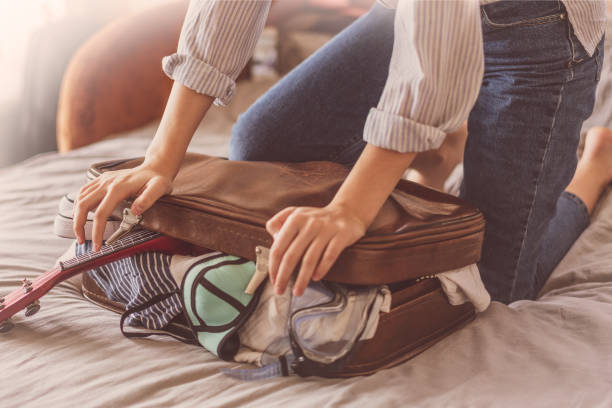 istock Female Packing Suitcase And Getting Ready For Traveling. Travel suitcase preparing concept 1158514536