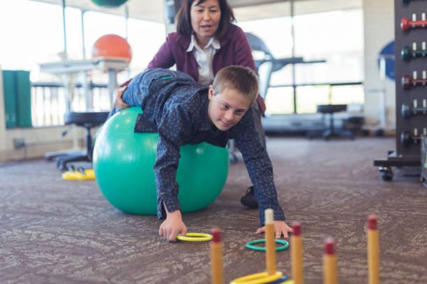 istock A boy does workouts with an occupational therapist at a physiotherapy clinic 1158514857