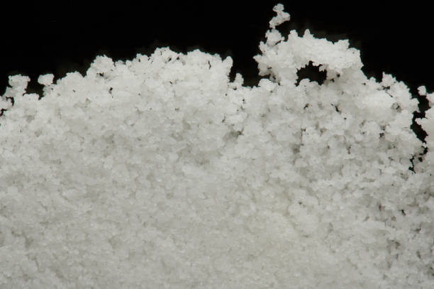 Pile of salt crystiles isolated on black background macro view