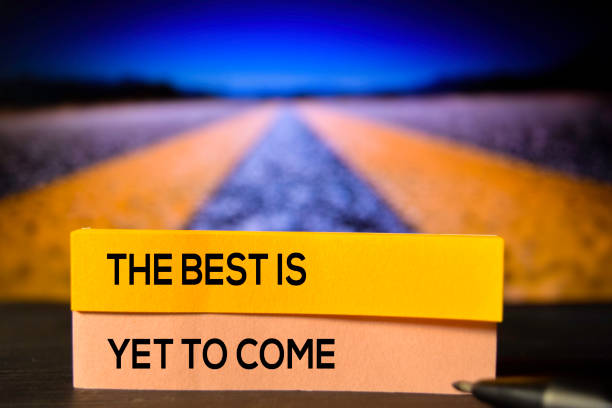The Best Is Yet To Come on the sticky notes with bokeh background